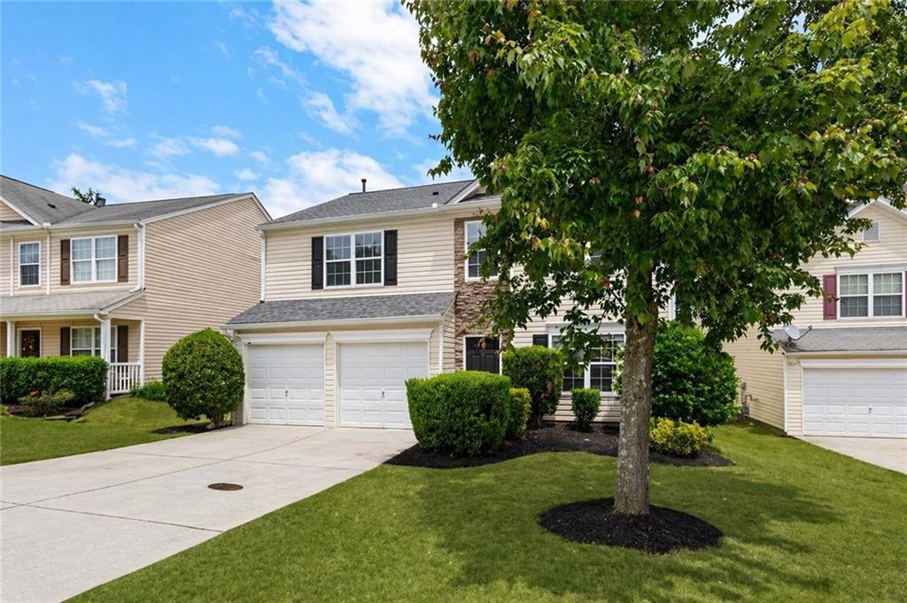 411 Sugar Maple Court Canton, GA 30114 - Photo 2 of 34 a front view of a house with a yard