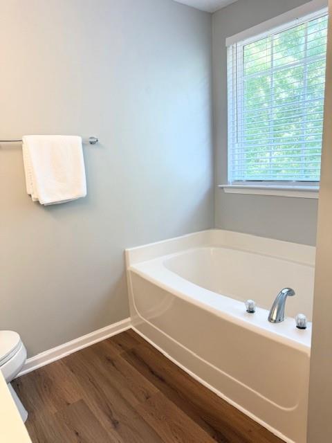 411 Sugar Maple Court Canton, GA 30114 - Photo 22 of 34 a bathroom with a bathtub and a window