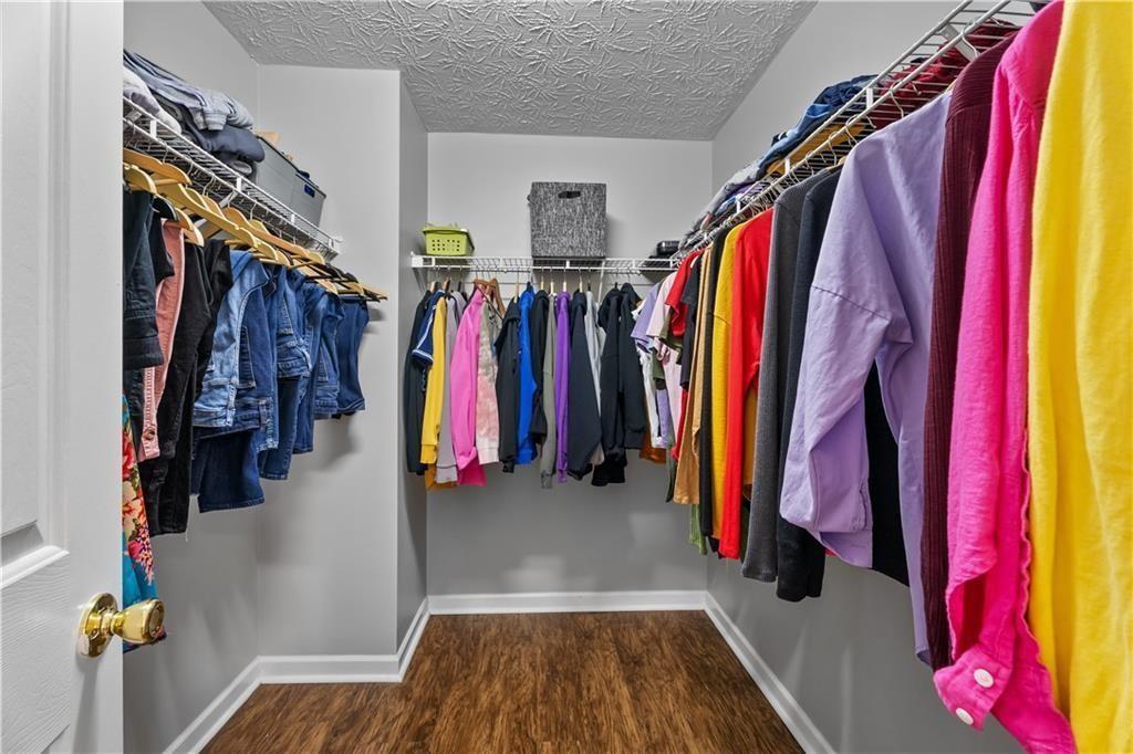 411 Sugar Maple Court Canton, GA 30114 - Photo 23 of 34 a view of walk in closet with clothes