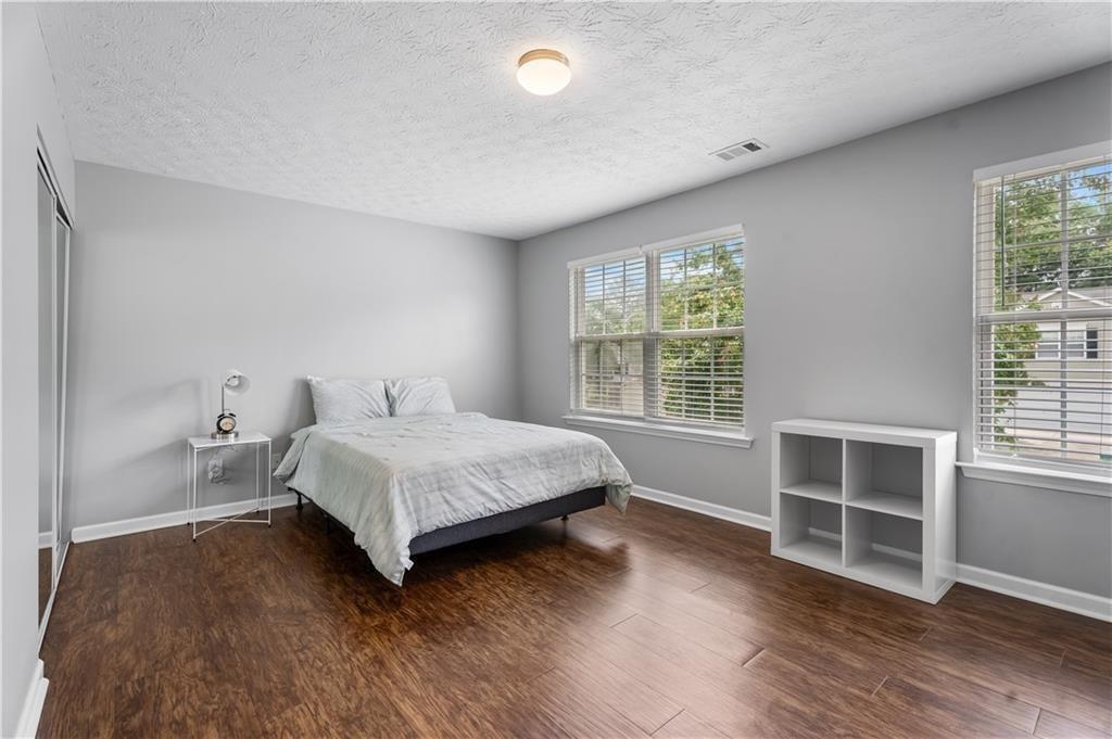 411 Sugar Maple Court Canton, GA 30114 - Photo 26 of 34 a bedroom with a bed and a window