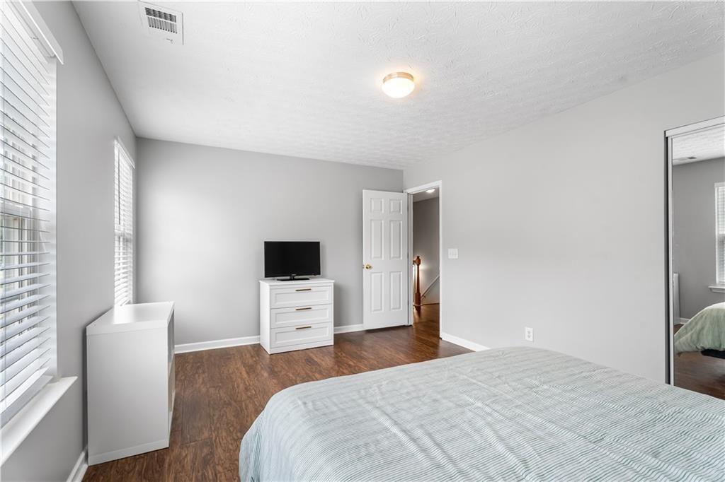 411 Sugar Maple Court Canton, GA 30114 - Photo 27 of 34 a bedroom with a bed and furniture