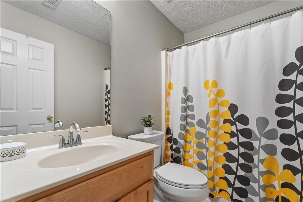 411 Sugar Maple Court Canton, GA 30114 - Photo 29 of 34 a bathroom with a sink and a toilet