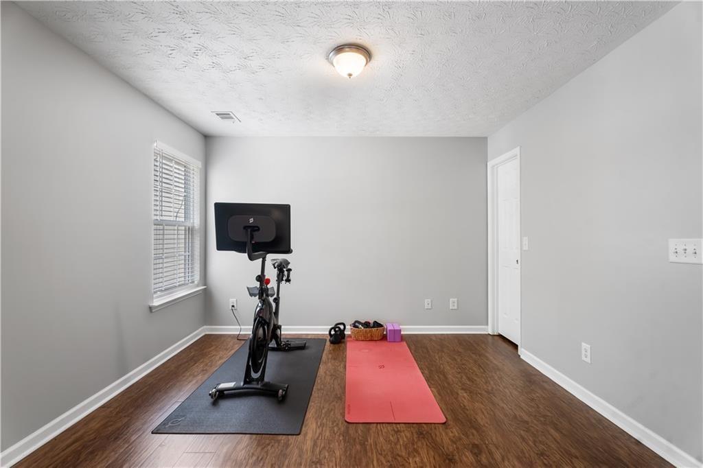 411 Sugar Maple Court Canton, GA 30114 - Photo 30 of 34 a view of a room with gym equipment
