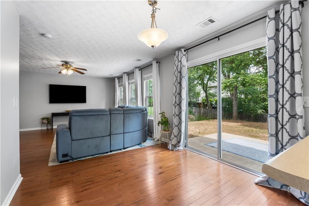 411 Sugar Maple Court Canton, GA 30114 - Photo 3 of 34 a view of livingroom with furniture wooden floor and window