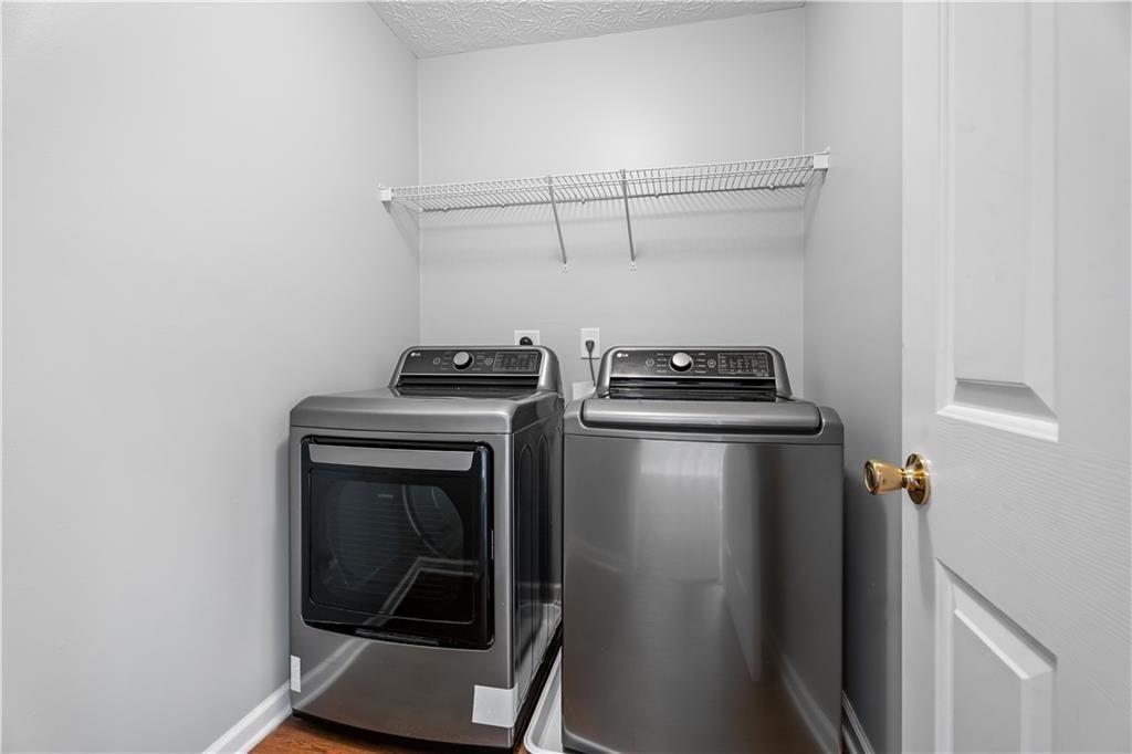 411 Sugar Maple Court Canton, GA 30114 - Photo 32 of 34 a view of storage and utility room with washer and dryer
