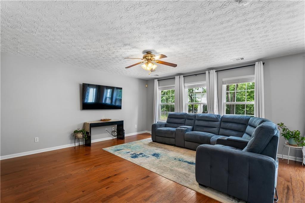 411 Sugar Maple Court Canton, GA 30114 - Photo 5 of 34 a living room with furniture and a flat screen tv