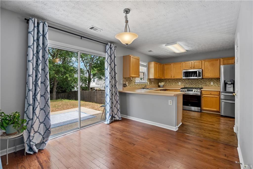411 Sugar Maple Court Canton, GA 30114 - Photo 6 of 34 a view of a kitchen with microwave and stove