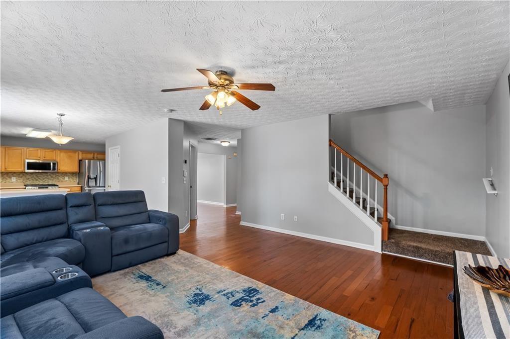 411 Sugar Maple Court Canton, GA 30114 - Photo 7 of 34 a living room with furniture and a wooden floor
