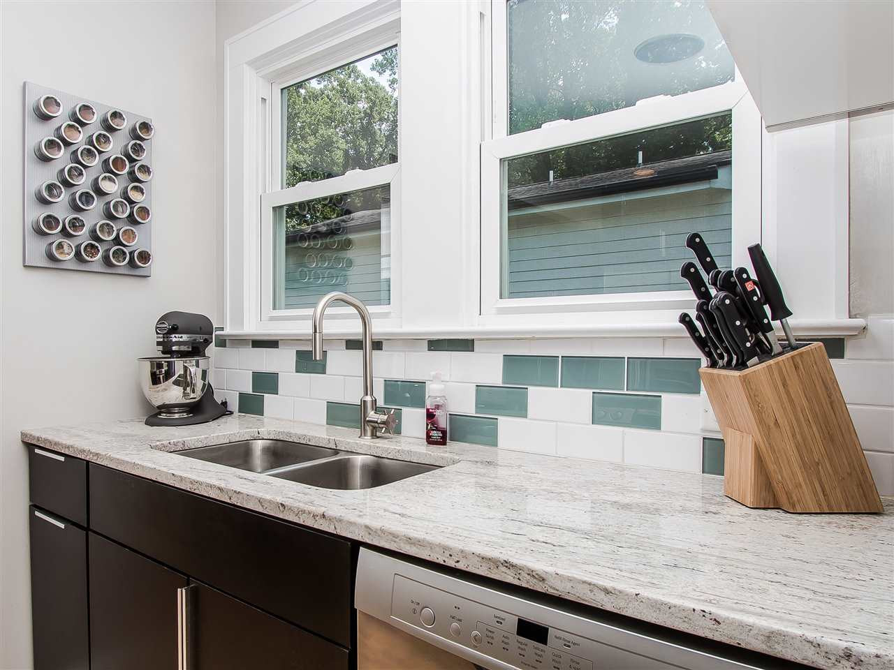 1634 Bickett Boulevard Raleigh, NC 27608 - Photo 11 of 25 Double stainless sink with pull out high end faucet. Tile back splash with fabulous granite counter tops. Kitchen