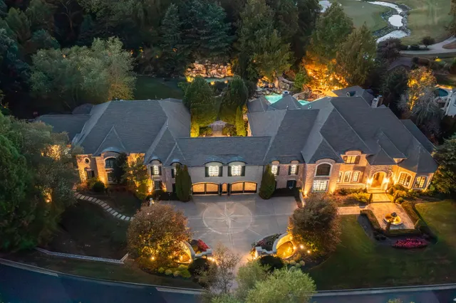 an aerial view of a house with yard swimming pool and outdoor seating