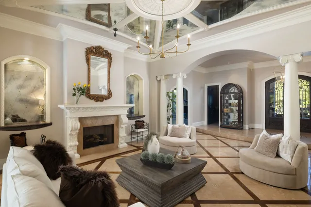 a view of a hallway with wooden floor and chandelier