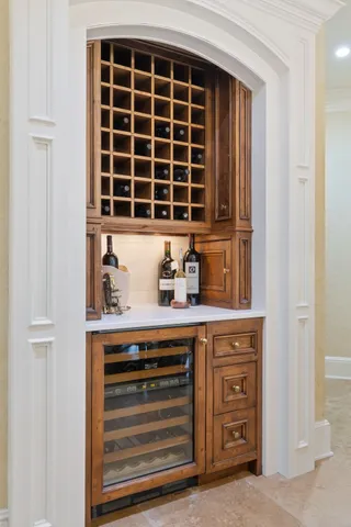 a view of a hallway with furniture and a window