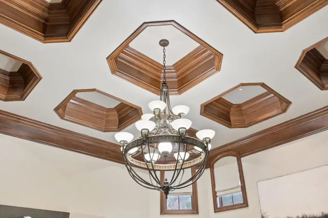 a living room with furniture a chandelier fan and a fireplace