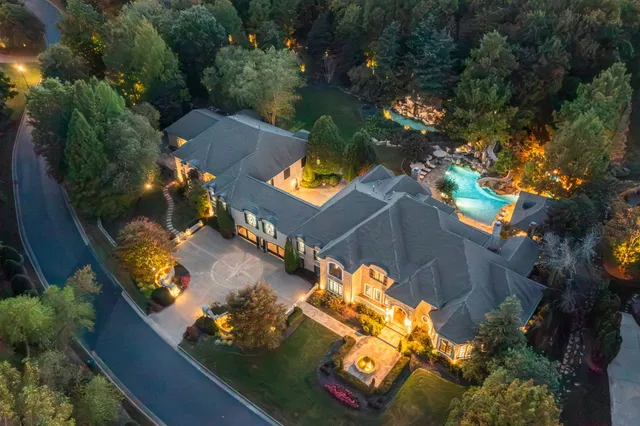 an aerial view of a house with yard swimming pool and outdoor seating