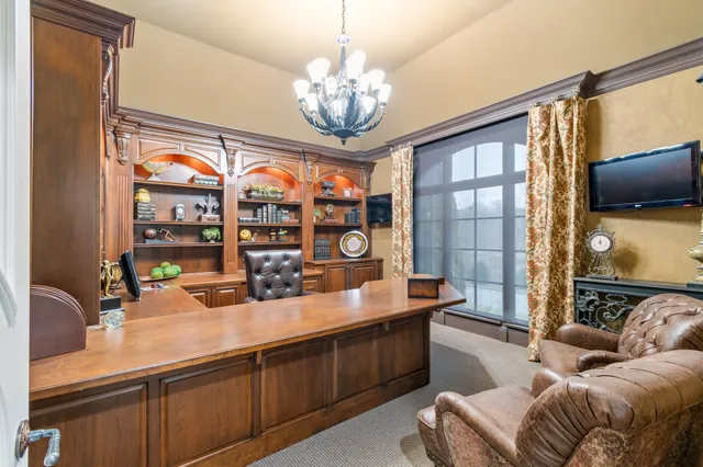 a view of a house with pool and sitting area