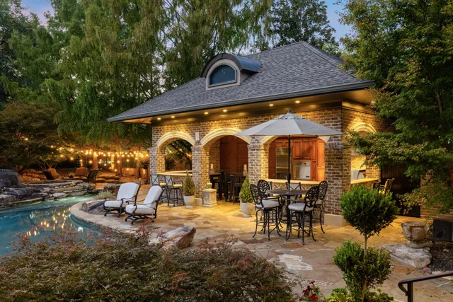 a living room with furniture a fireplace and a chandelier