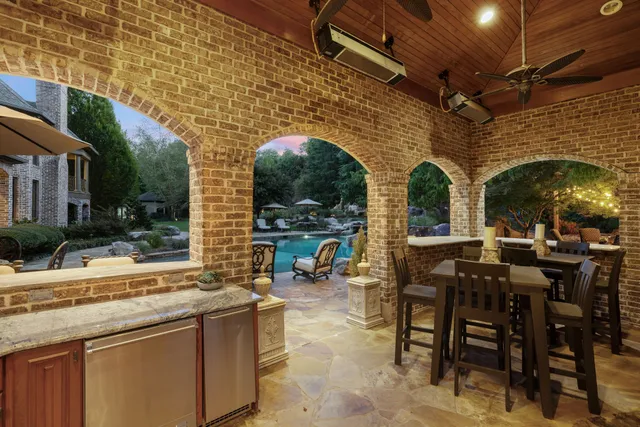 a kitchen with granite countertop a sink a counter top space and stainless steel appliances