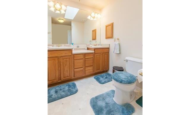 1038 Bowstring Road Monument, CO 80132 - Photo 13 of 25 a bathroom with a sink toilet and mirror