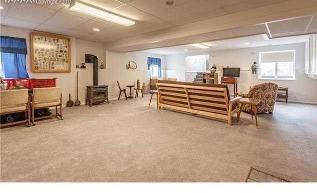 1038 Bowstring Road Monument, CO 80132 - Photo 14 of 25 a bedroom with furniture and a chair
