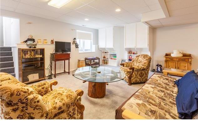 1038 Bowstring Road Monument, CO 80132 - Photo 15 of 25 a living room with furniture and a flat screen tv