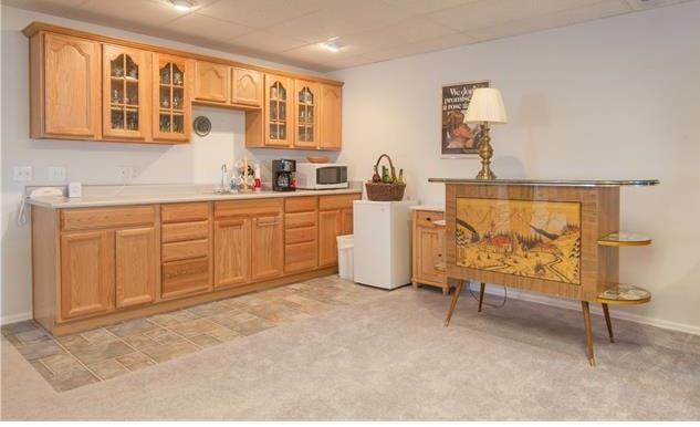 1038 Bowstring Road Monument, CO 80132 - Photo 16 of 25 a spacious bedroom with a bed and a table in it