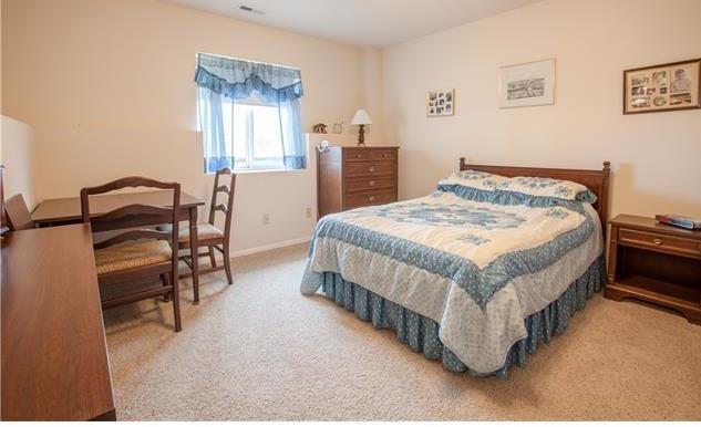 1038 Bowstring Road Monument, CO 80132 - Photo 19 of 25 a bedroom with a bed and a table