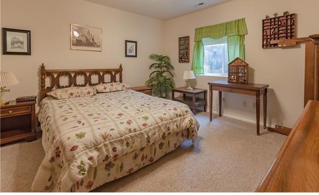 1038 Bowstring Road Monument, CO 80132 - Photo 21 of 25 a bedroom with a bed and a table in it