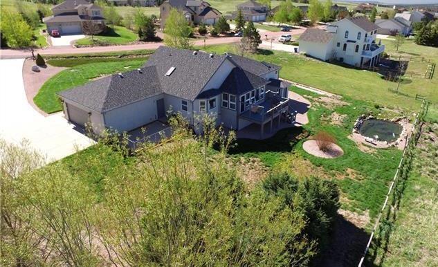1038 Bowstring Road Monument, CO 80132 - Photo 24 of 25 an aerial view of a house with garden space and street view