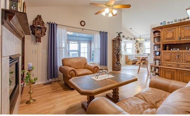 1038 Bowstring Road Monument, CO 80132 - Photo 4 of 25 a living room with furniture and a chandelier