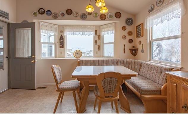 1038 Bowstring Road Monument, CO 80132 - Photo 5 of 25 a view of a dining room with furniture and a large window