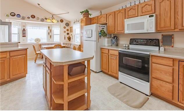 1038 Bowstring Road Monument, CO 80132 - Photo 6 of 25 a kitchen with stainless steel appliances granite countertop a sink stove and refrigerator