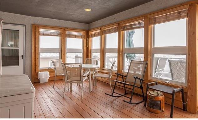 1038 Bowstring Road Monument, CO 80132 - Photo 9 of 25 a living room with furniture and floor to ceiling windows