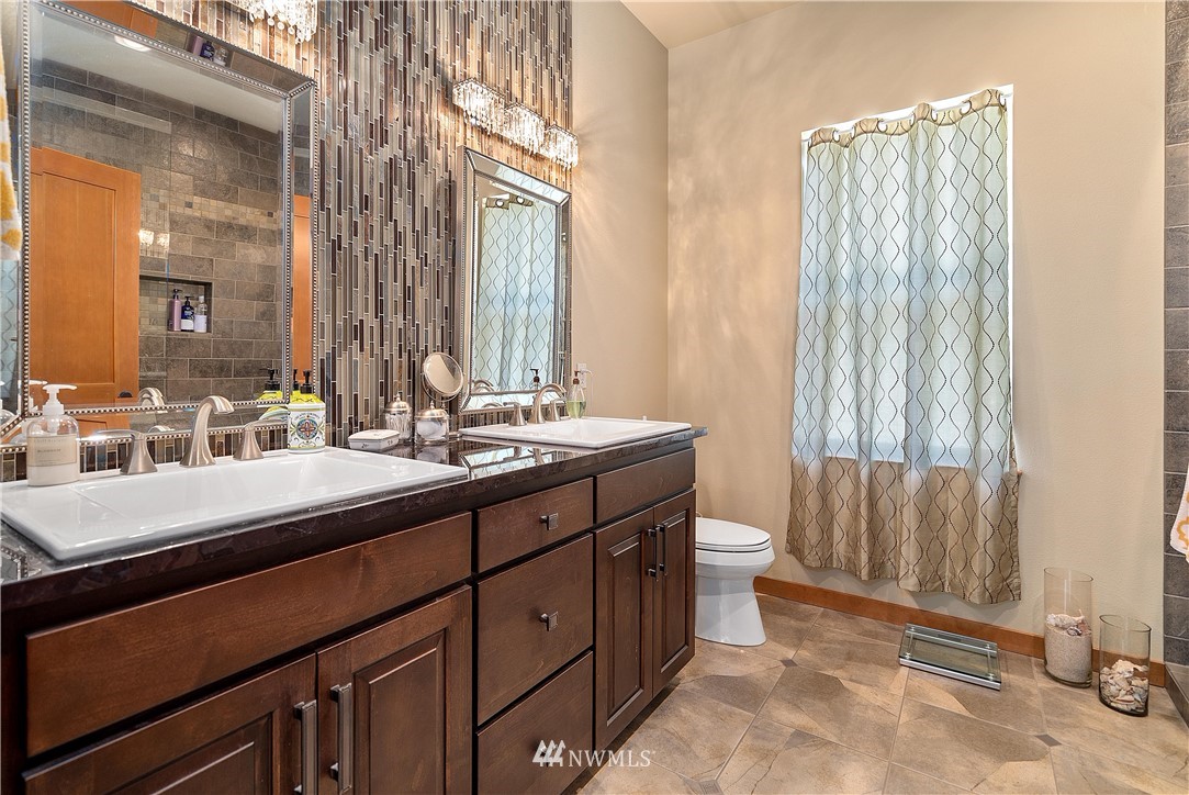 178 Jeffries Road Chehalis, WA 98532 - Photo 5 of 19 a bathroom with a double vanity sink a toilet and a mirror