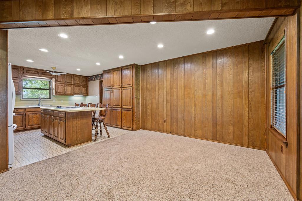 515 New Highland Road Springtown, TX 76082 - Photo 15 of 38 Kitchen featuring wood cabinetry, a center island with seating, recessed lighting, and a ceiling fan