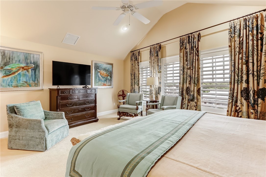 2384 South Fletcher Avenue Fernandina Beach, FL 32034 - Photo 14 of 35 a bedroom with a bed television and a large window