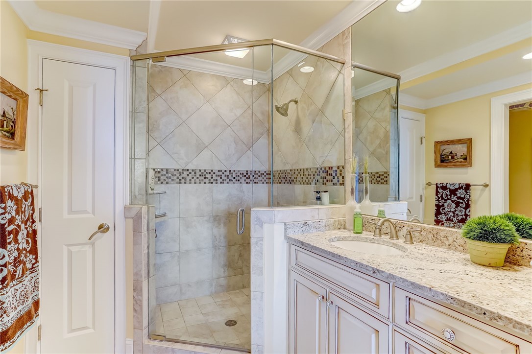 2384 South Fletcher Avenue Fernandina Beach, FL 32034 - Photo 18 of 35 a bathroom with a granite countertop shower sink and vanity