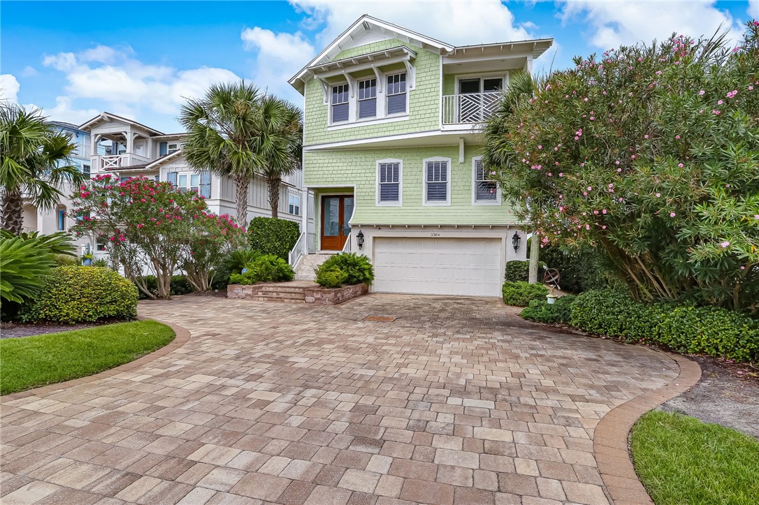 2384 South Fletcher Avenue Fernandina Beach, FL 32034 - Photo 2 of 35 a front view of a house with a yard and a garage