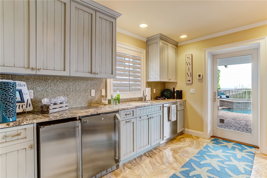 2384 South Fletcher Avenue Fernandina Beach, FL 32034 - Photo 27 of 35 a kitchen with a sink refrigerator and cabinets