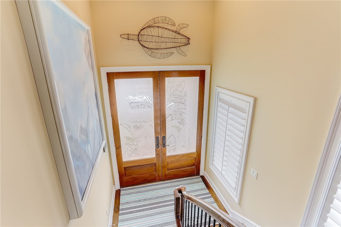 2384 South Fletcher Avenue Fernandina Beach, FL 32034 - Photo 3 of 35 a view of a hallway with wooden floor and stairs