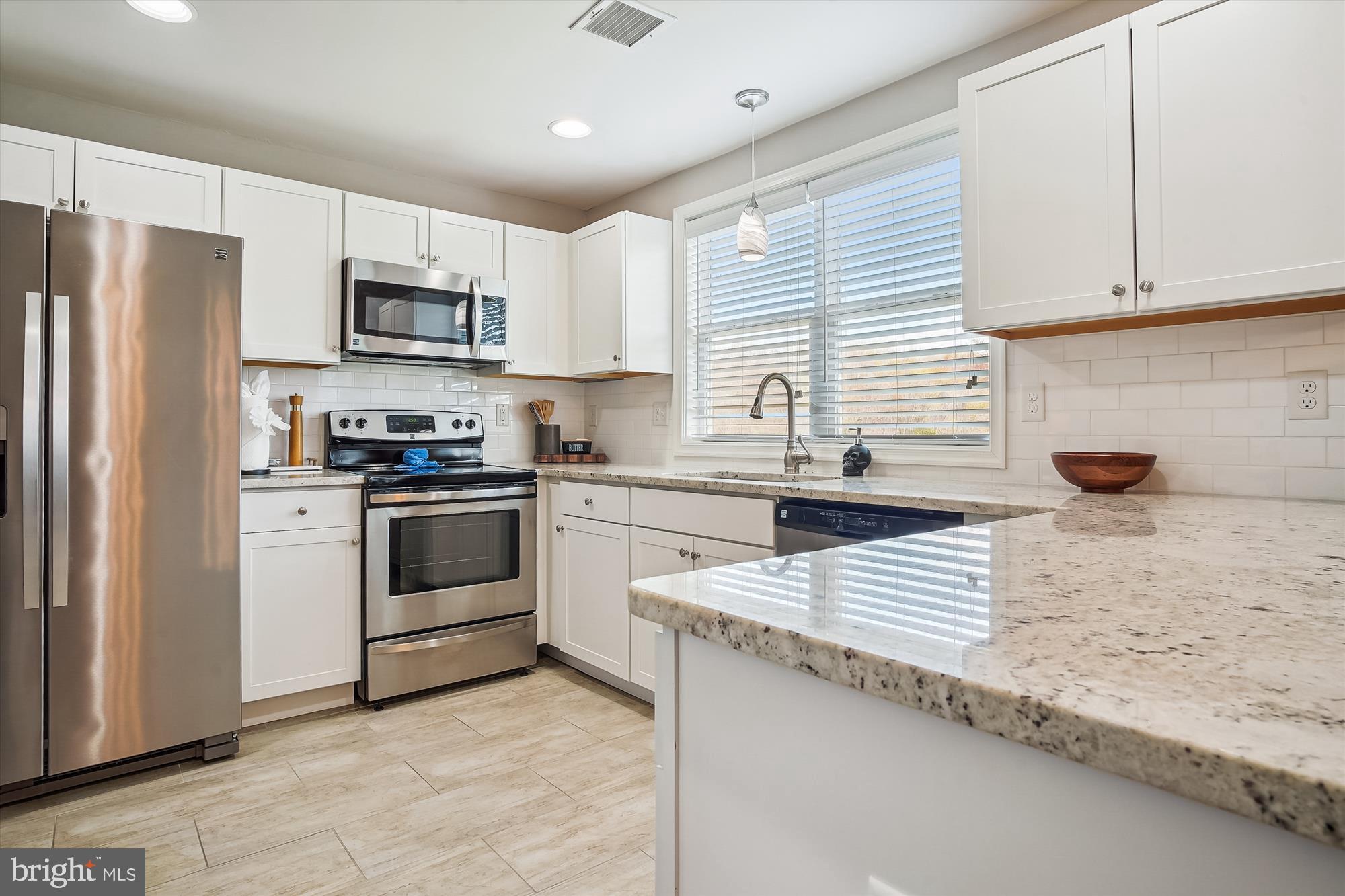 2554 Church Hill Road Centreville, MD 21617 - Photo 11 of 27 a kitchen with white cabinets and white appliances
