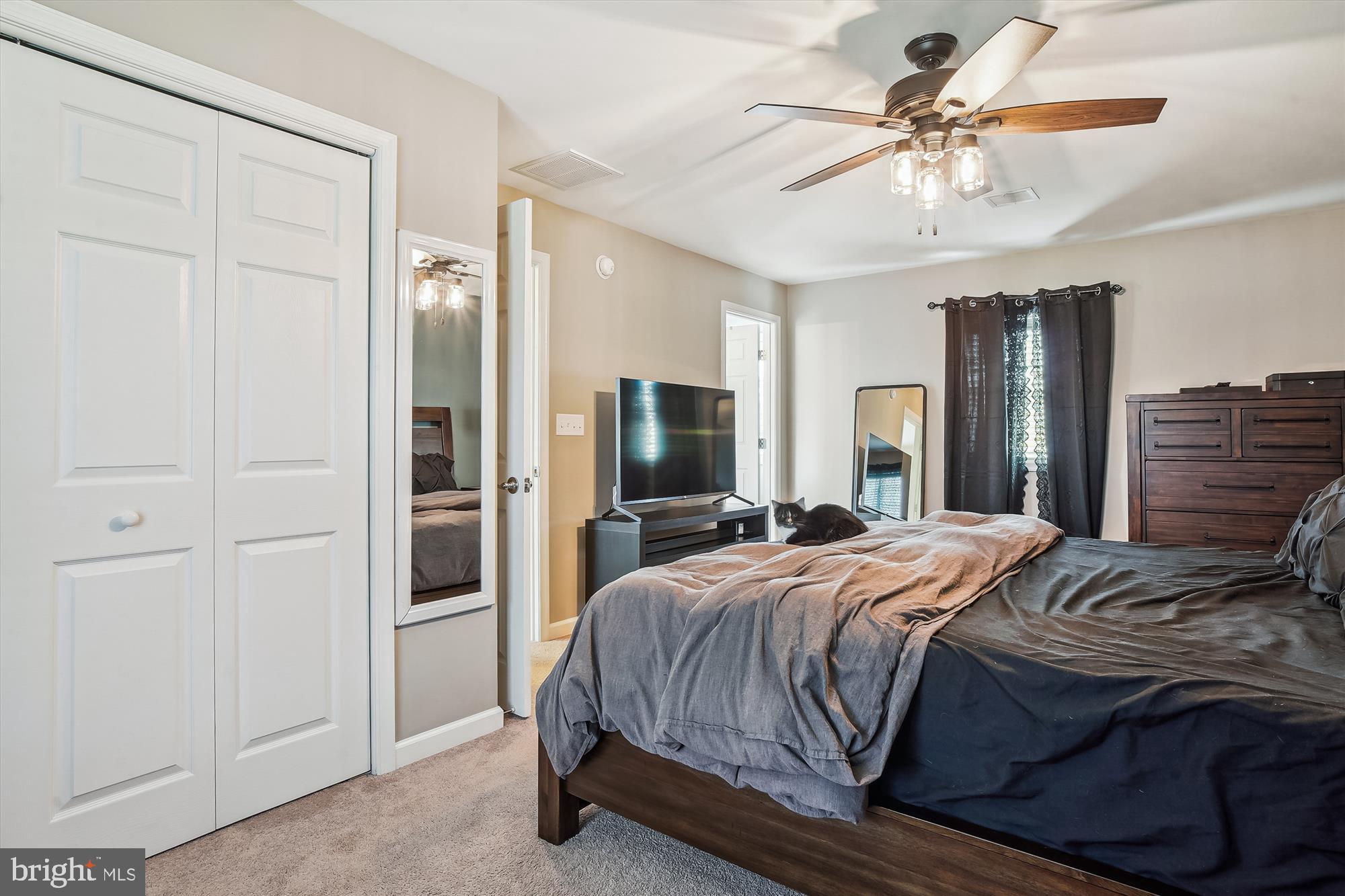 2554 Church Hill Road Centreville, MD 21617 - Photo 15 of 27 a bedroom with a bed and a chandelier