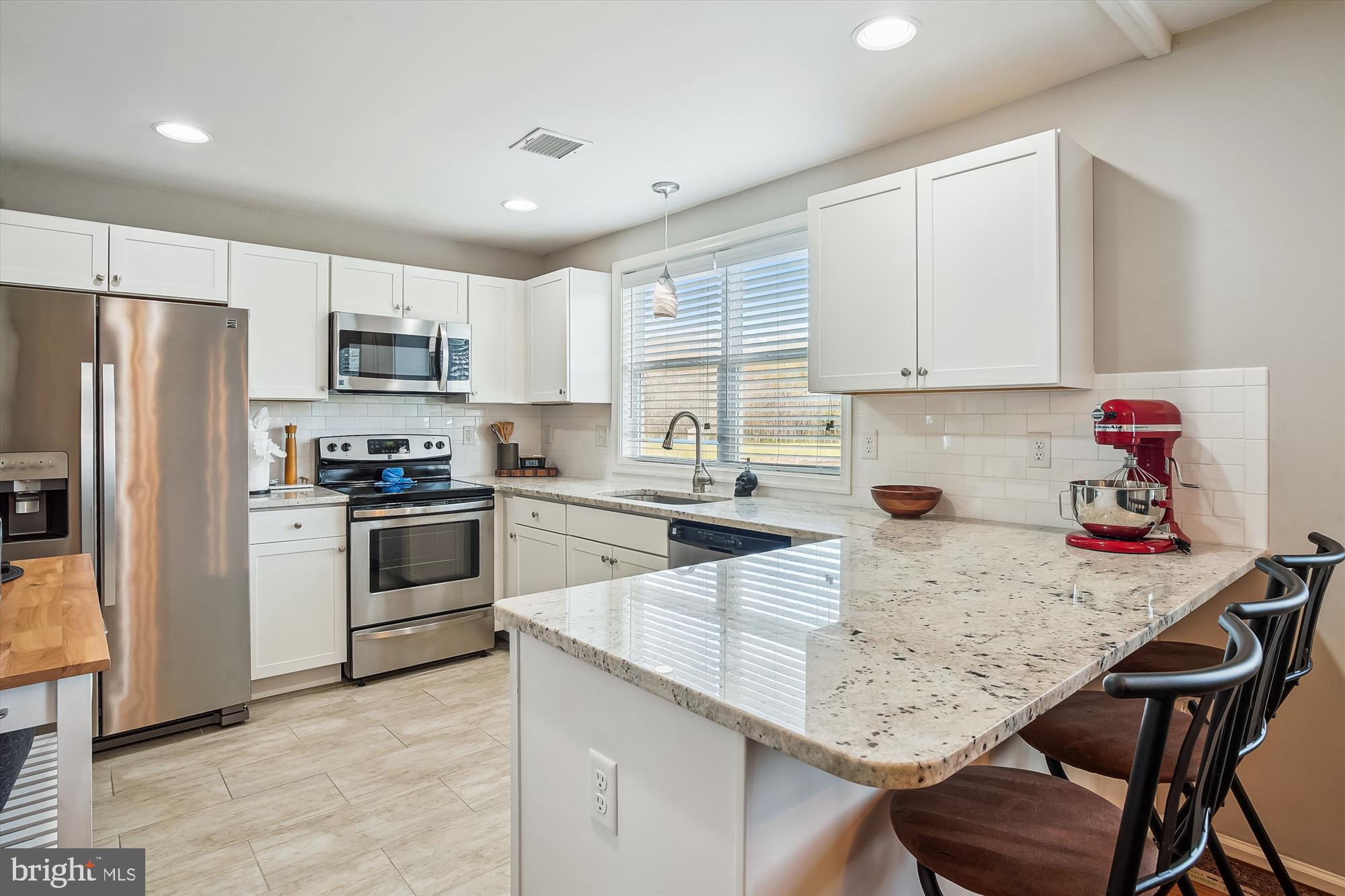 2554 Church Hill Road Centreville, MD 21617 - Photo 10 of 27 a kitchen with kitchen island a white counter top space cabinets stainless steel appliances and cabinets