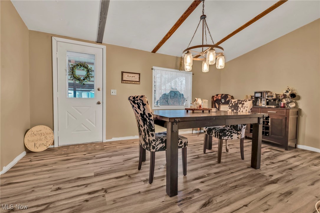 2131 Gordon Road Northwest Dover, OH 44622 - Photo 3 of 25 Dining area with vaulted ceiling with beams and light hardwood / wood-style floors