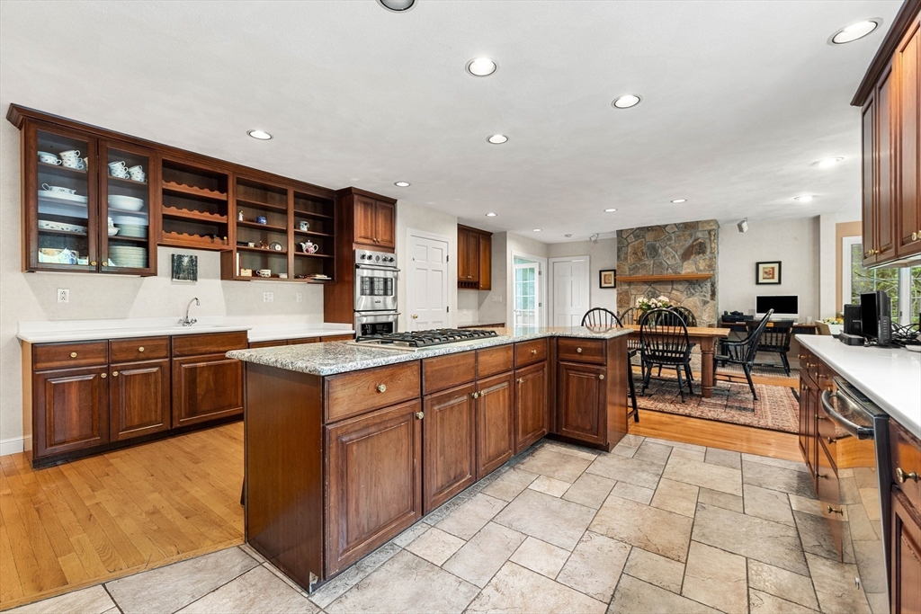 37 Old Planters Road Beverly, MA 01915 - Photo 11 of 42 a kitchen with stainless steel appliances granite countertop a stove and a sink