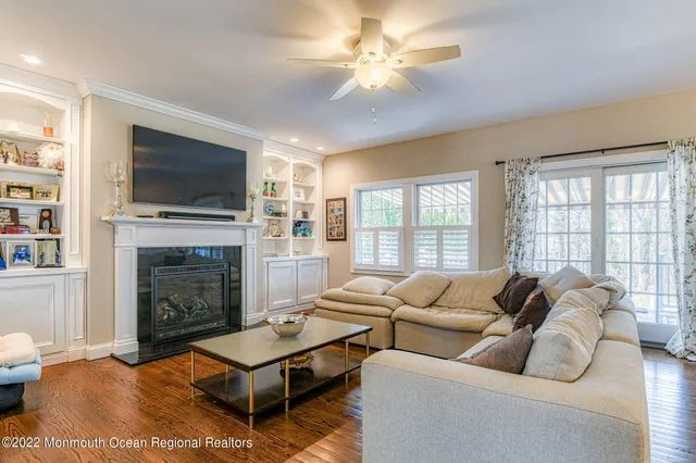 a living room with furniture large window and a fireplace