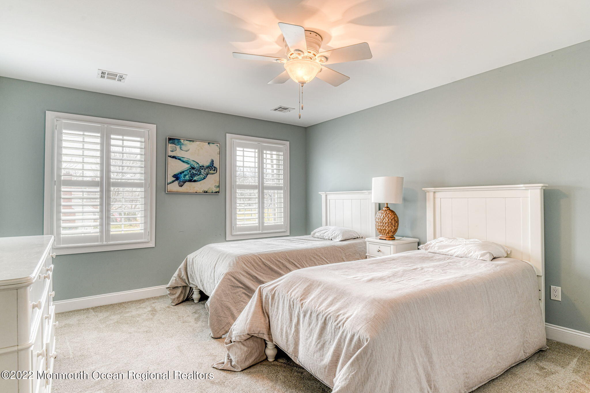 346 South Boulevard Spring Lake, NJ 07762 - Photo 30 of 56 a bedroom with a large bed and a chandelier