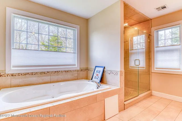 a bathroom with a granite countertop toilet sink and mirror