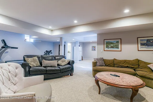 a room with furniture pool table and window