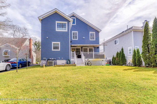 a view of a house with a small yard and wooden floor and fence