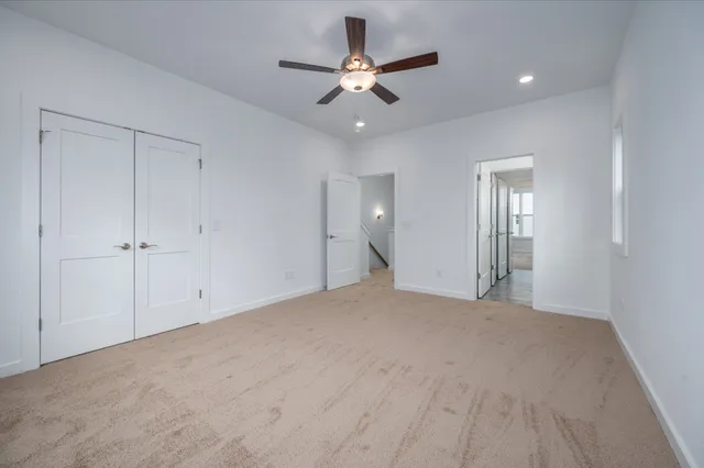 a view of an empty room with a ceiling fan
